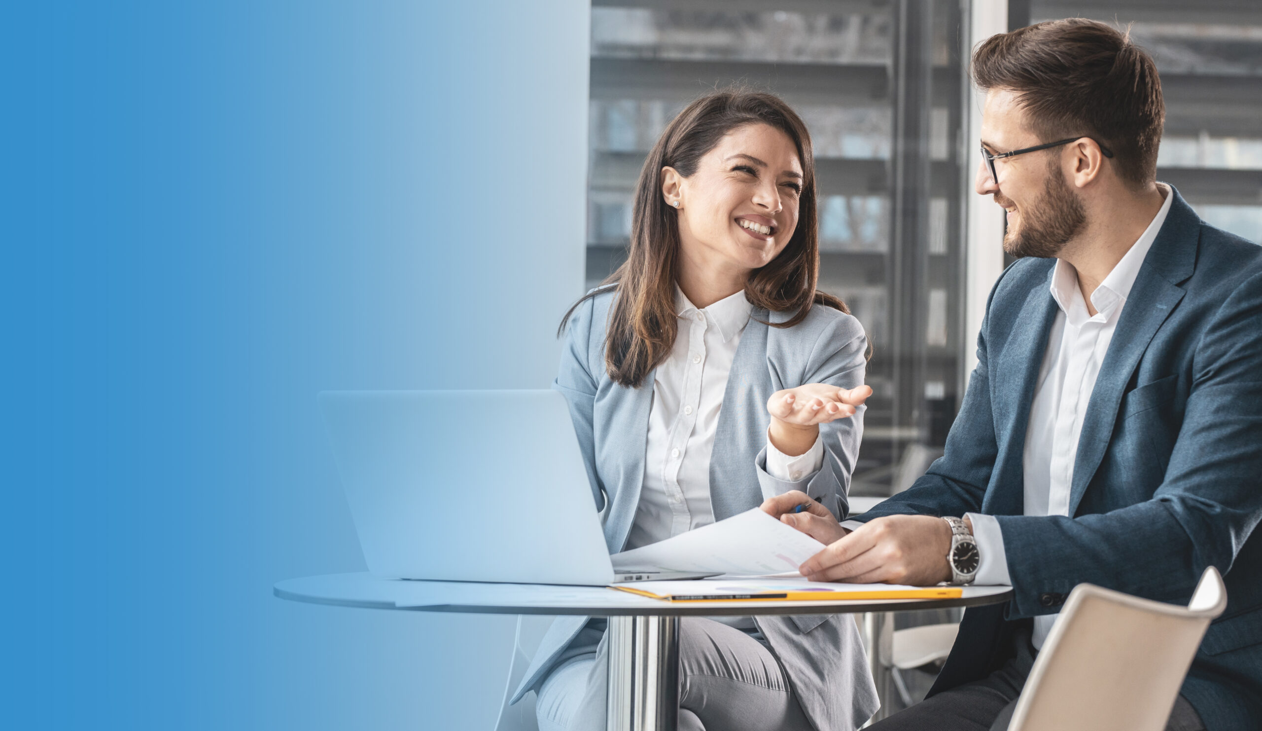 Waist up portrait of creative young woman smiling at camera and holding digital tablet while standing in modern office, copy space